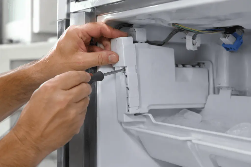 Ice maker not working: empty ice bin and wire arm inside a home freezer